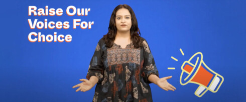 A woman stands against a blue background, wearing a patterned dress. Text reads 